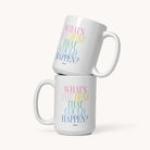 Two white ceramic Simplified mugs are stacked, each featuring the phrase “WHAT’S THE BEST THAT COULD HAPPEN?” in pastel pink, yellow, teal, and blue on a plain background. Product: Mug, Best That Could Happen.