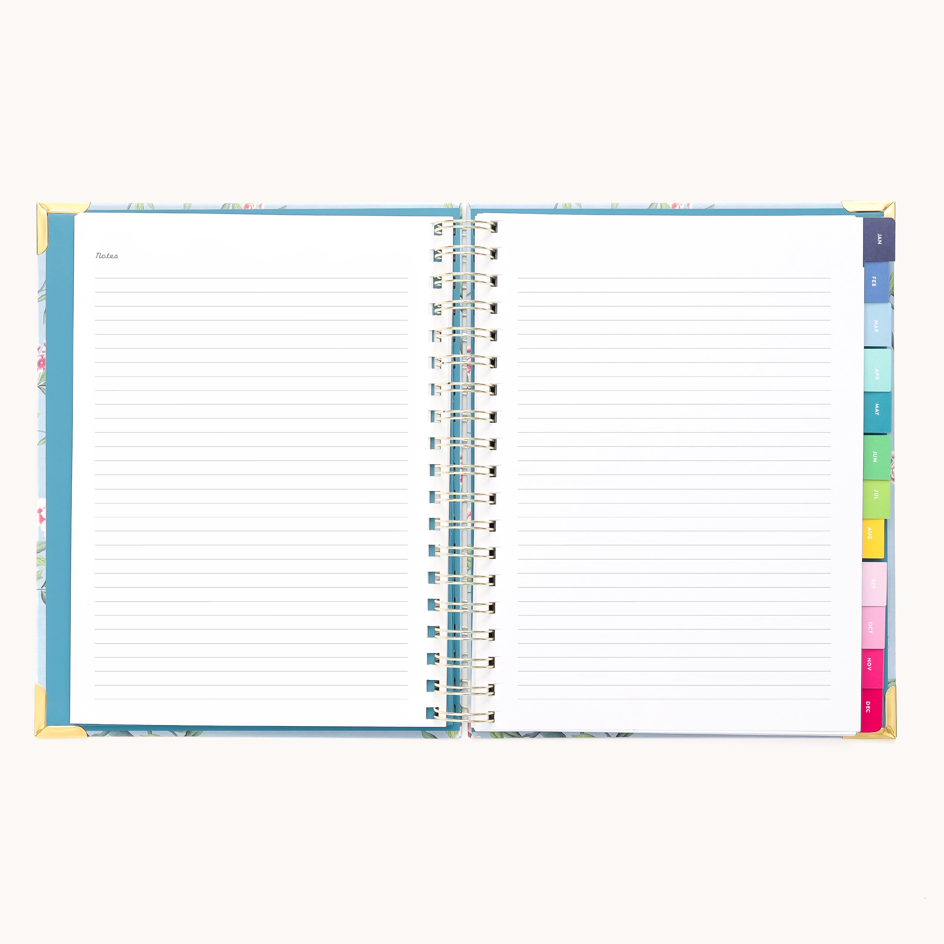 An open 2026 Spiral Weekly Simplified Planner – Faraway Land by Simplified lays flat on a light background, showing lined Notes pages and colorful tab dividers, perfect for organizing your weekly tasks.