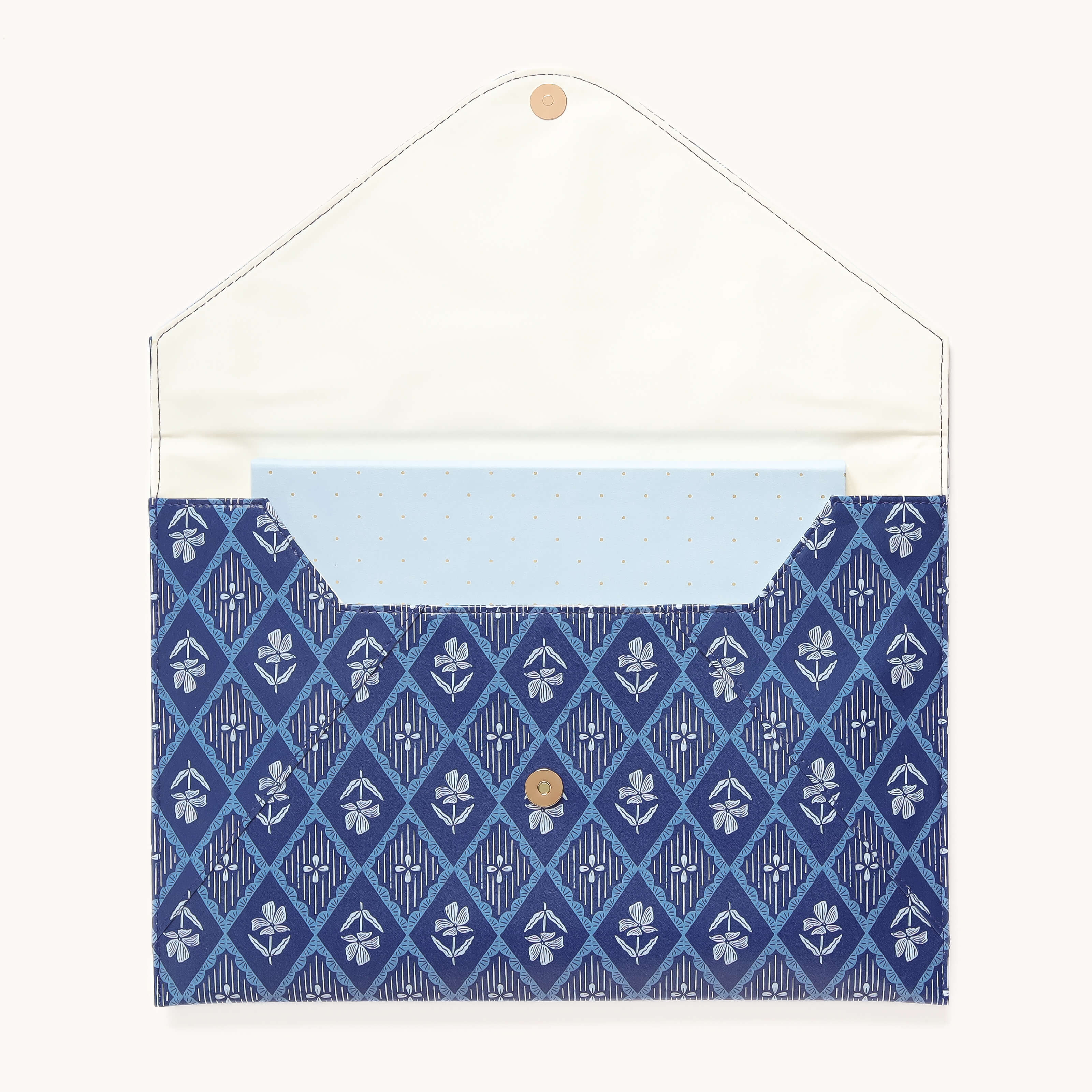 The Simplified Leatherette Tech Case - Block Floral, shown open on a plain background, features a patterned blue envelope style, a white interior flap, a light blue dotted inner pocket, and a button closure.
