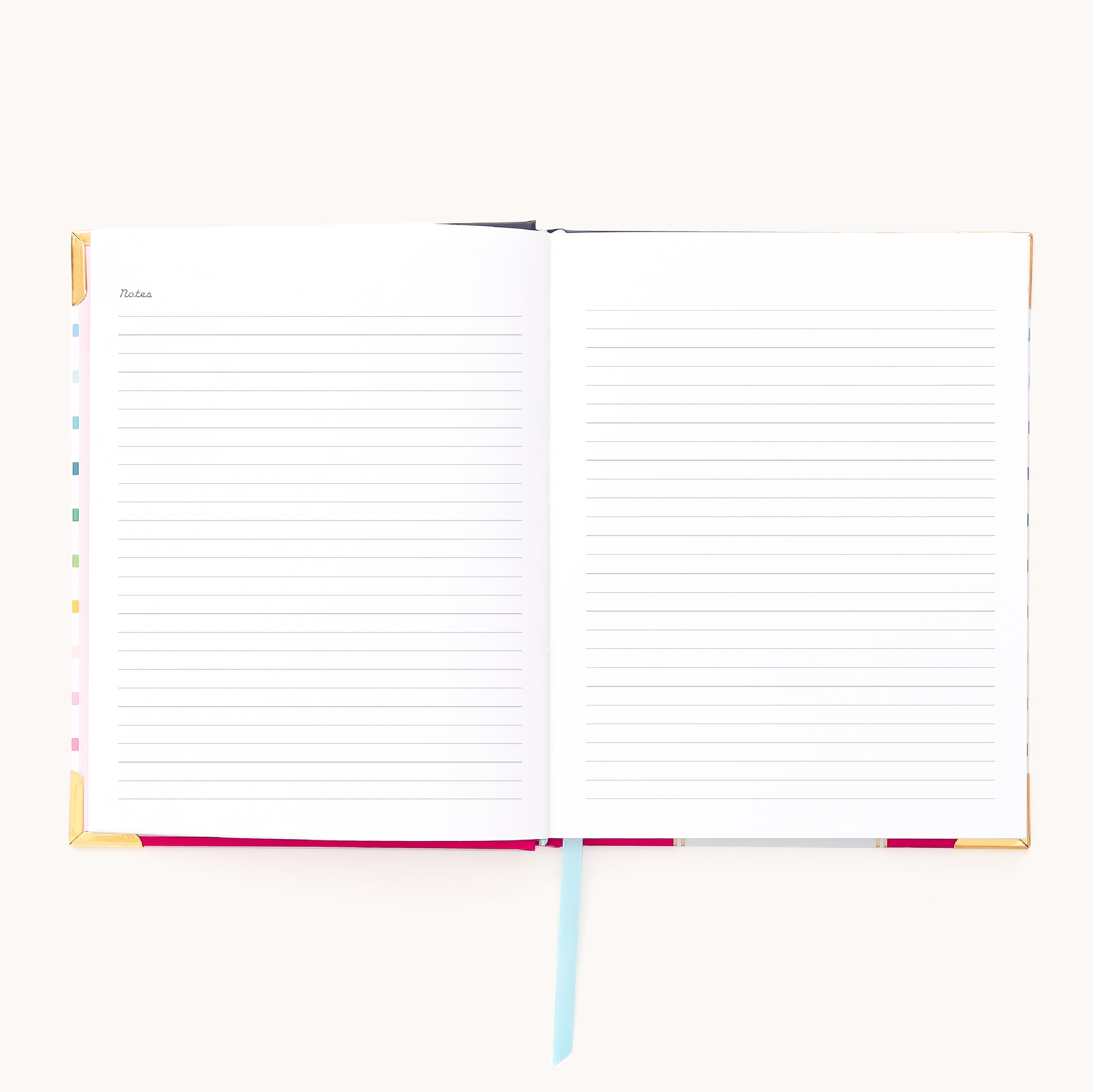 The Simplified 2026 Bookbound Weekly Simplified Planner – Happy Stripe features lay-flat binding, lined pages, and a light blue ribbon bookmark, with Notes labeled on the top left page, ready for writing on a white background.