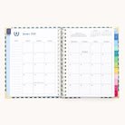 The 2026 Spiral Weekly Simplified Planner - Camp Gingham by Simplified displays a January 2026 calendar on the left and a lined notes section with colored tab dividers on the right, featuring a clean, minimal design.