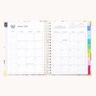The Simplified 2026 Spiral Weekly Simplified Planner - Cottage Floral is open to January’s monthly calendar, showing tabbed section dividers on the right and a notes column on the left, with a subtle floral-patterned background.