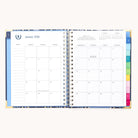 The 2026 Spiral Weekly Simplified Planner - Poppy Posies by Simplified opens to a January 2026 calendar with lined notes on the left, colorful section tabs on the right, and a small yearly calendar in the top right corner.