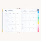 August monthly spread in bookbound weekly planner with calendar grid for planning goals, events, and routines