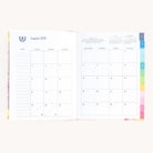 August monthly spread in bookbound weekly planner with calendar grid for planning goals, events, and routines