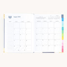 August monthly spread in bookbound weekly planner with calendar grid for planning goals, events, and routines