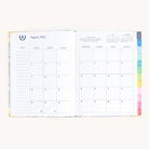 August monthly spread in bookbound weekly planner with calendar grid for planning goals, events, and routines