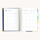 August monthly spread in spiral daily planner with clean calendar grid for scheduling, goal setting, and simplified planning