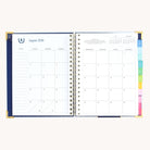 August monthly calendar spread in spiral weekly planner with clean layout for scheduling and goal setting
