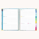 The Simplified 2026 Spiral Weekly Simplified Planner – Faraway Land shows two pages with lined daily sections dated for January, plus colorful tab dividers along the right edge.