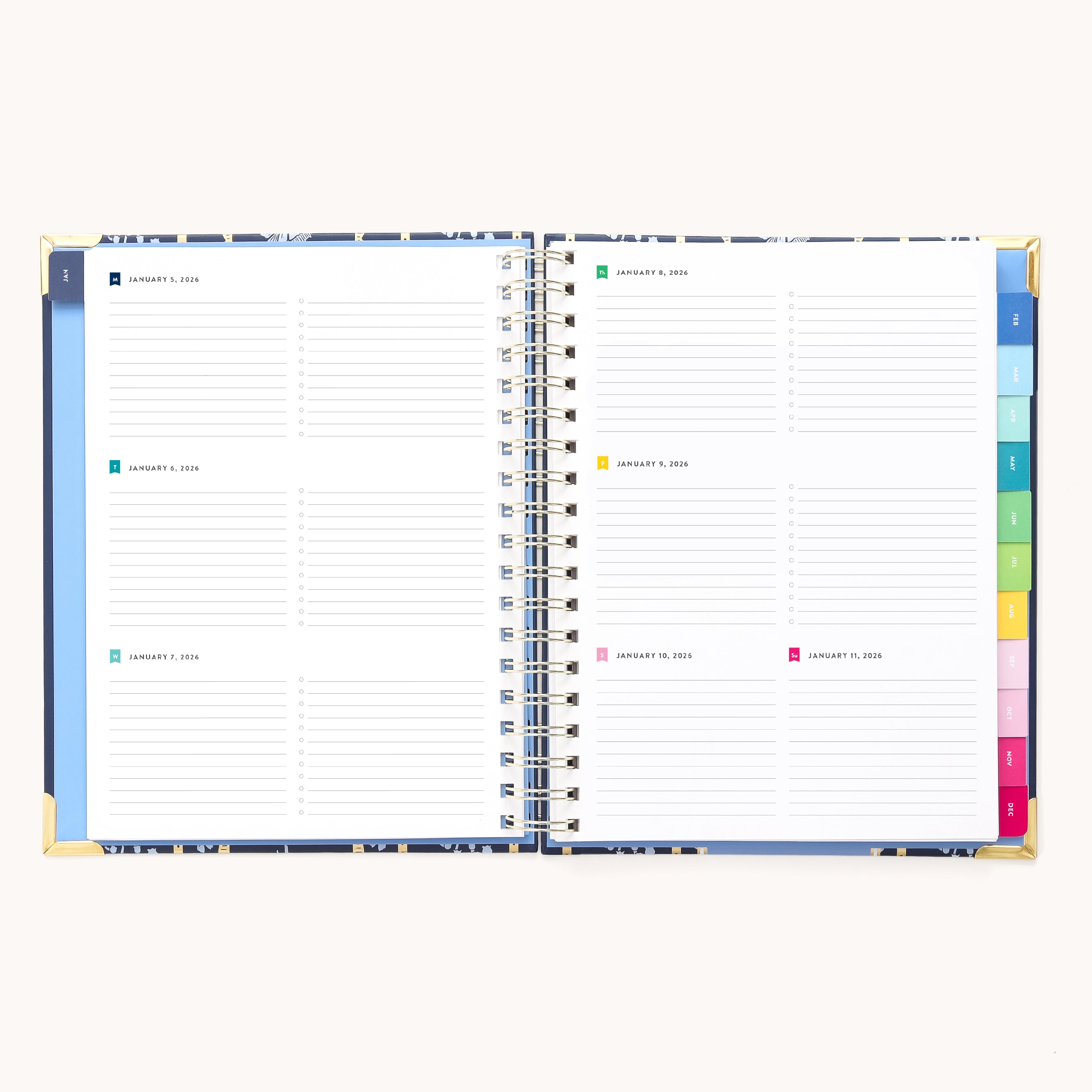 The 2026 Spiral Weekly Simplified Planner - Poppy Posies by Simplified is open to a weekly layout with lined sections for each day, colorful tab dividers on the right, and elegant gold corner protectors.