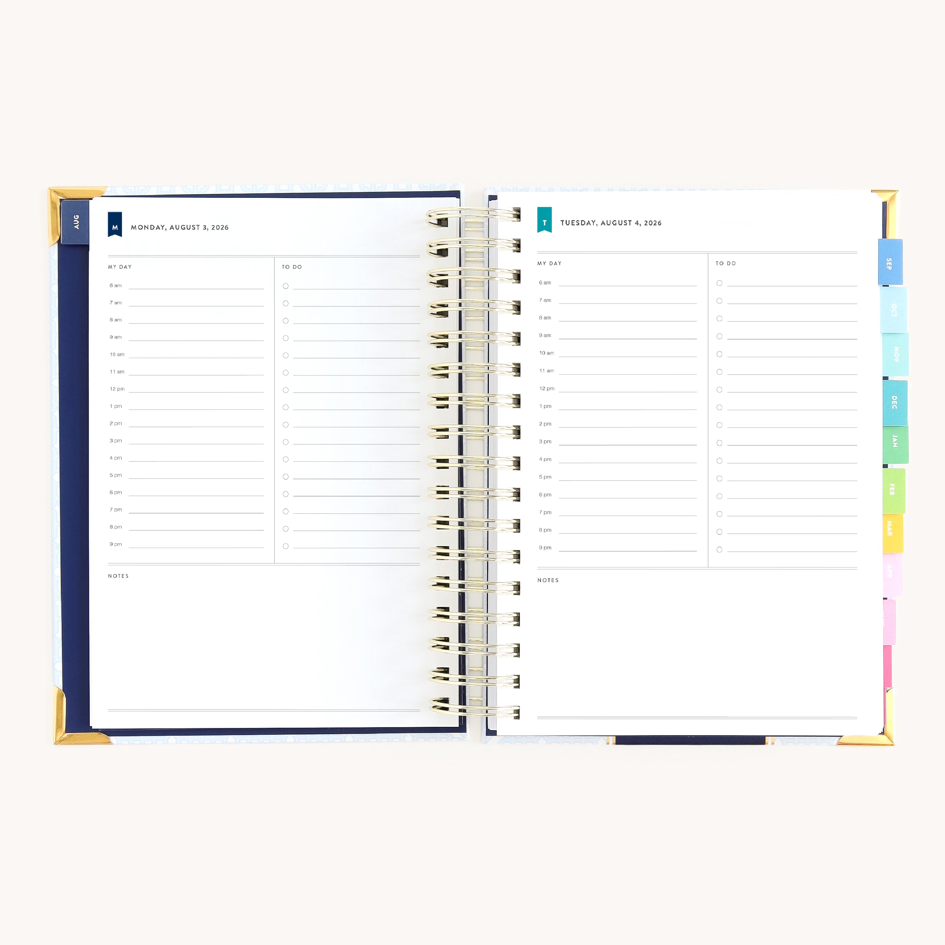 Spiral daily planner open to Monday and Tuesday pages with hourly schedule, to-do lists, and space for notes