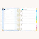 Spiral daily planner open to Monday and Tuesday pages with hourly schedule, to-do lists, and space for notes
