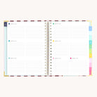 Spiral weekly planner open to weekly layout with space for appointments, to-do lists, and notes