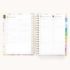 The 2026 Spiral Daily Simplified Planner - Cottage Floral by Simplified is open to Friday, Saturday, and Sunday daily pages with hourly schedules, to-do lists, notes, and colorful monthly tabs on the right side.