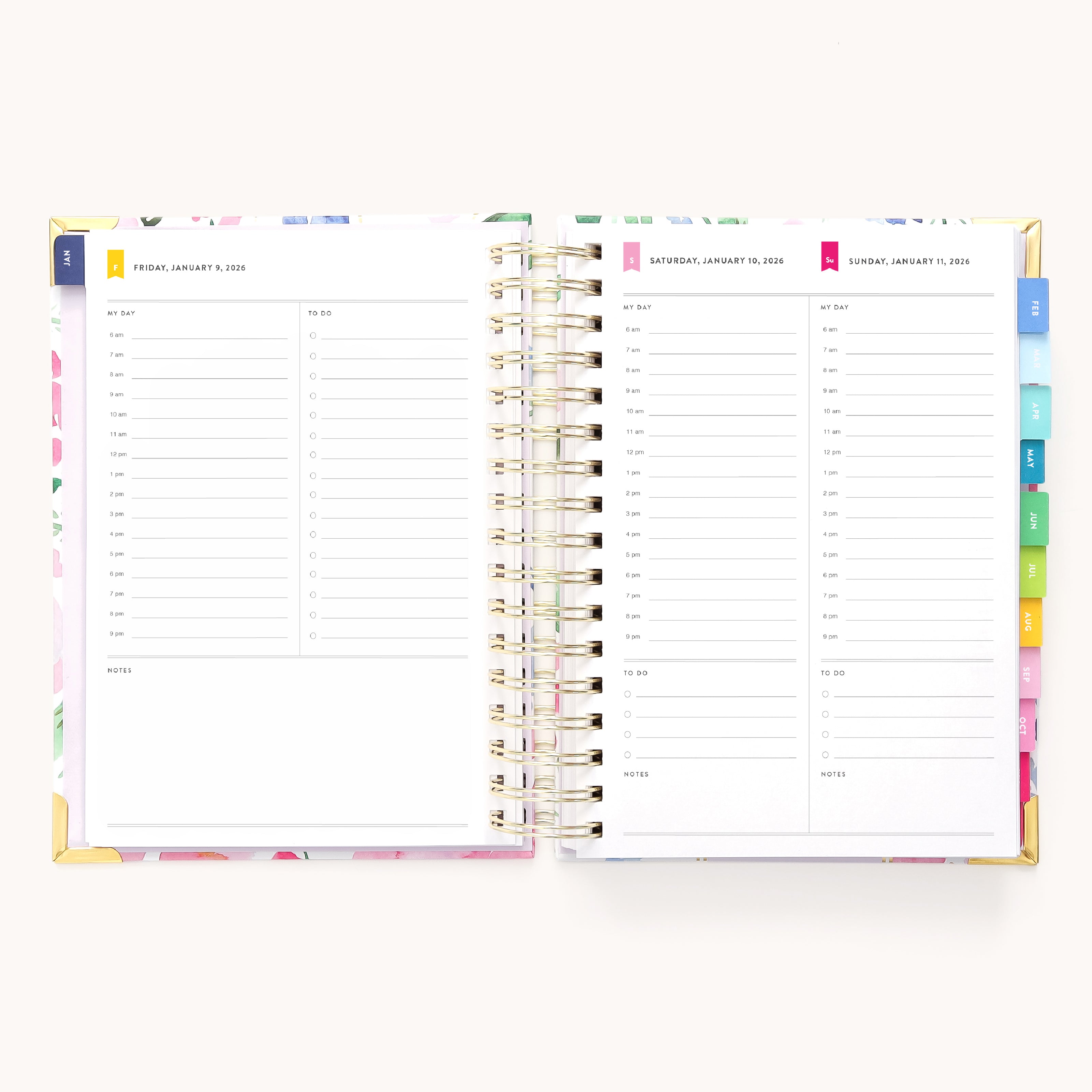 The 2026 Spiral Daily Simplified Planner - Cottage Floral by Simplified is open to Friday, Saturday, and Sunday daily pages with hourly schedules, to-do lists, notes, and colorful monthly tabs on the right side.