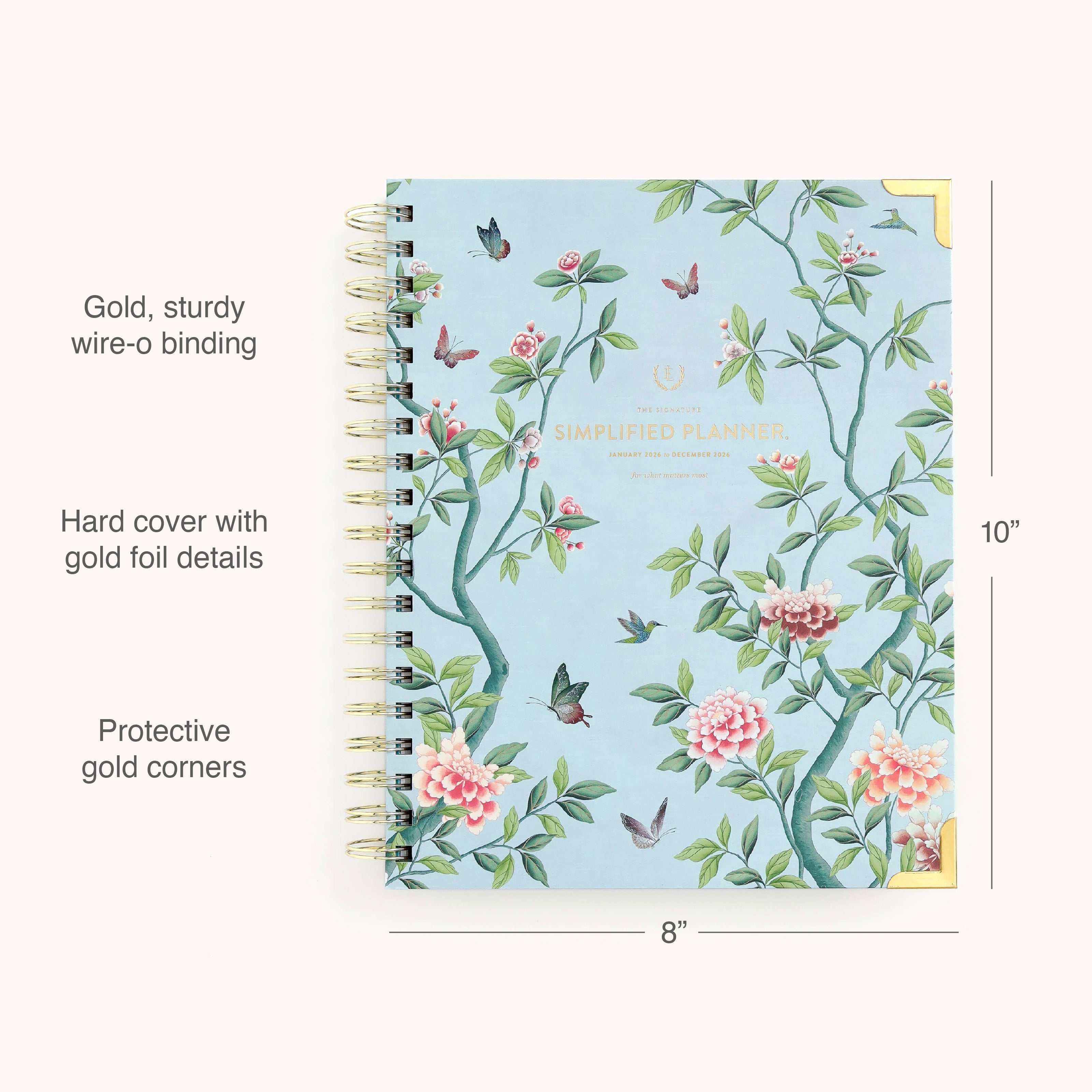 The 2026 Spiral Weekly Simplified Planner - Faraway Land by Simplified features a blue hardcover with floral and bird motifs, gold foil accents, protective gold corners, and gold wire-o binding. Size: 10 x 8. Perfect for your weekly planning needs.
