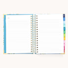 The 2026 Spiral Daily Simplified Planner - Faraway Land by Simplified features an open spiral design with lined pages, gold corner protectors, and colored tab dividers on the right. The left page is labeled Notes, all set against a white background.