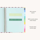 The 2026-2027 Spiral Weekly Simplified Planner - Berry Stripe by Simplified features a mint interior, new colorful sticker sheets in the center pocket, rainbow tab dividers, and a double-sided pocket page.