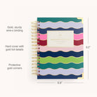 The 2026 Spiral Daily Simplified Planner - Rainbow Row by Simplified features wavy stripes, gold wire binding, gold foil accents, and protective corners. This stylish 12-month planner measures 9.2 x 6.8 for easy daily organization.