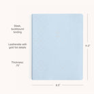 The Simplified 2026 Bookbound Weekly Dapperdesk Planner - Carolina Dot features a pale blue leatherette cover with gold foil dots, “2026” embossed at center, sleek bookbound binding, and measures 11.2 x 8.5 x 0.75.