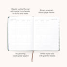 The Simplified 2026 Bookbound Weekly Dapperdesk Planner in Evergreen features a leatherette cover, vertical layout, brown grosgrain ribbon, white mylar tabs with gold foil, and offers dedicated space for schedules, to-do lists, notes, and no paper ghosting.