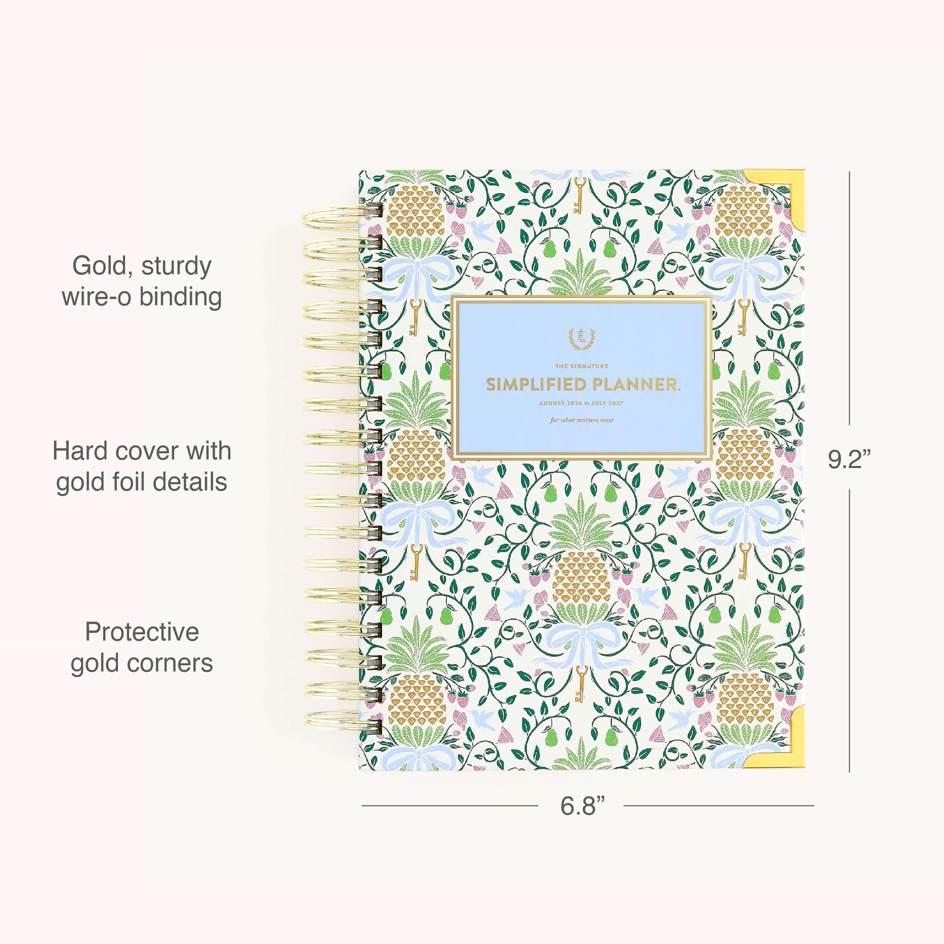 The Simplified 2026-2027 Spiral Daily Simplified Planner – Pineapple Charm features a colorful hardcover with gold wire-o binding, gold foil floral accents, and protective corners. Size: 9.2 x 6.8.