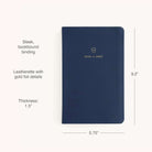 The Simplified 2026-2027 Bookbound Daily Dapperdesk Planner in Navy features a navy leatherette cover with gold foil crest, durable bookbound binding, and measures 9.2” x 5.75” x 1.5” for organized planning all year.