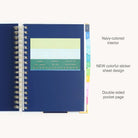 Spiral daily planner interior with storage pocket and sticker page for organizing reminders, notes, and planning essentials