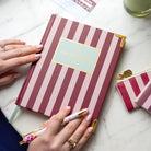 Berry Stripe bookbound weekly planner styled in a clean workspace for thoughtful planning and everyday organization