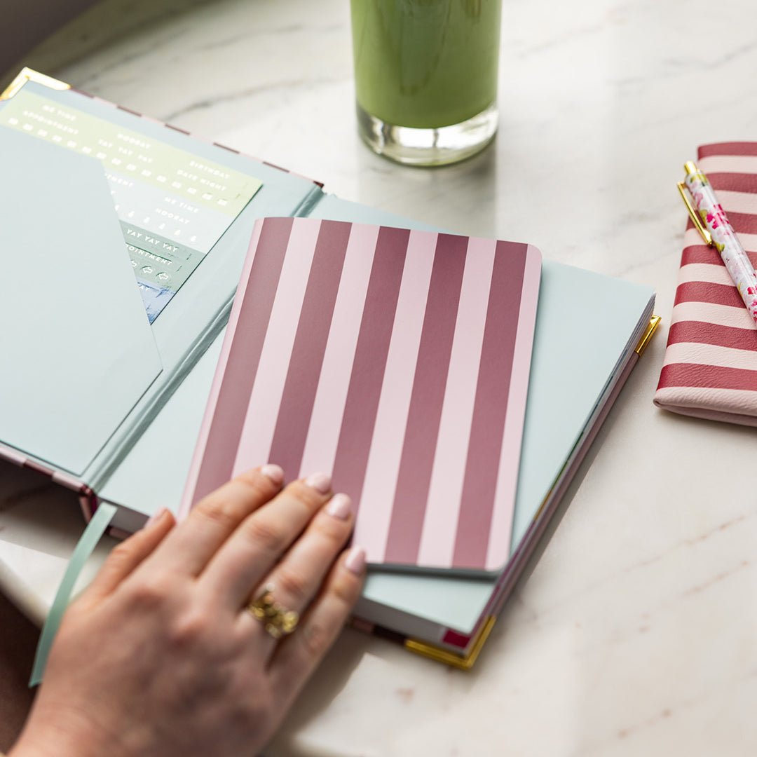 Berry Stripe mini notebook styled in an elegant workspace with cheerful details for jotting notes, lists, and ideas throughout the day