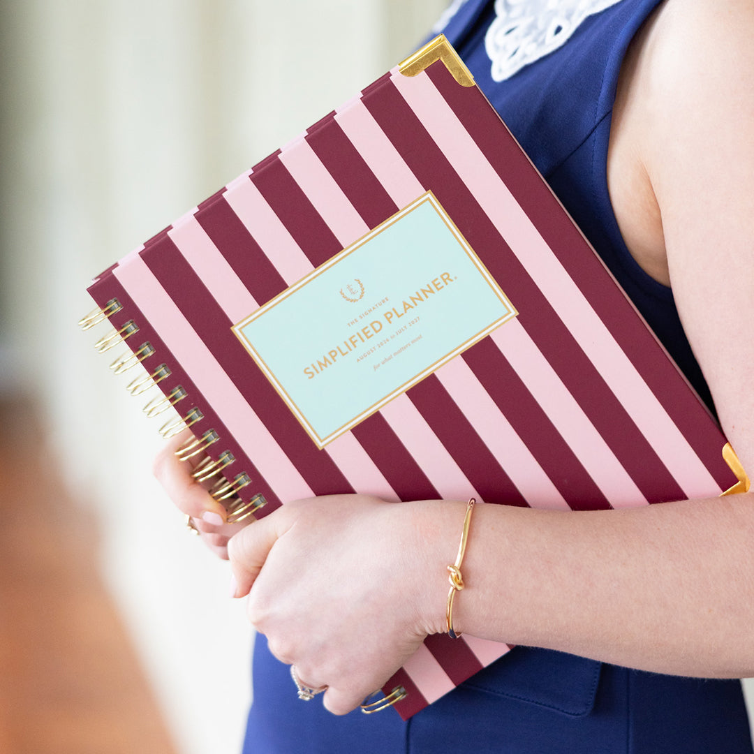 Woman holding spiral weekly planner 