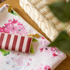 floral planner pouch styled on desk with striped accessory and gold zipper pull, perfect for organizing everyday essentials