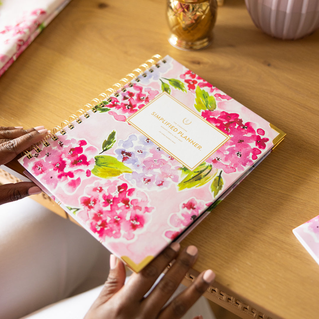 Blush Hydrangea spiral weekly planner styled on desk with elegant accessories for cheerful, organized planning