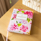 Blush Hydrangea bookbound weekly planner styled in a clean workspace for thoughtful planning and everyday organization