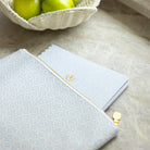 Blue planner pouch styled on desk with striped accessory and gold zipper pull, perfect for organizing everyday essentials