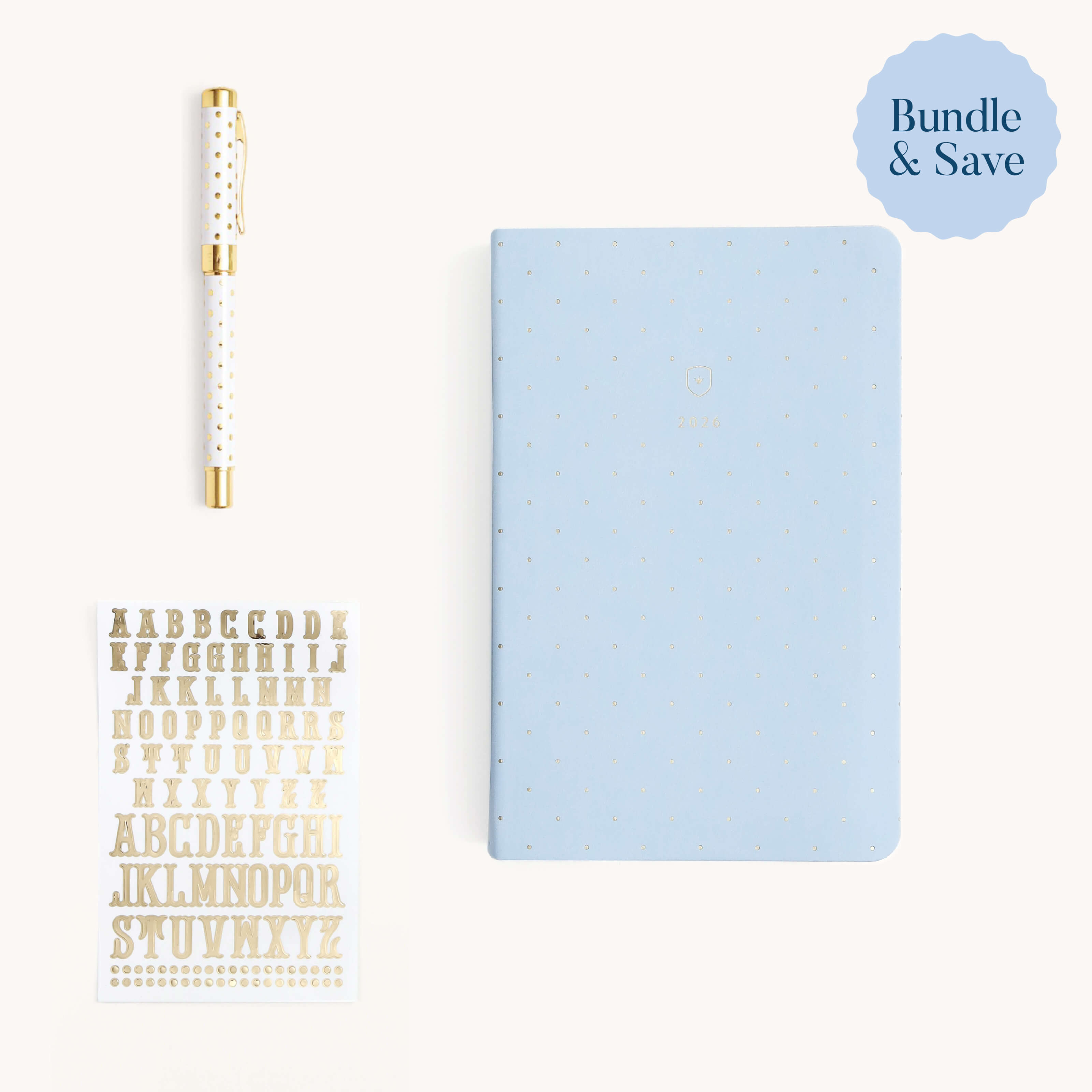 The Simplified® by Emily Ley Daily Dapperdesk Starter Bundle includes a pale blue dotted notebook, a gold-accented white pen, and gold alphabet stickers, all arranged on white with a Bundle & Save label in the top right corner.