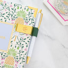 Evergreen pen clip used on planner to hold pen securely with a simple, elegant solution for everyday organization