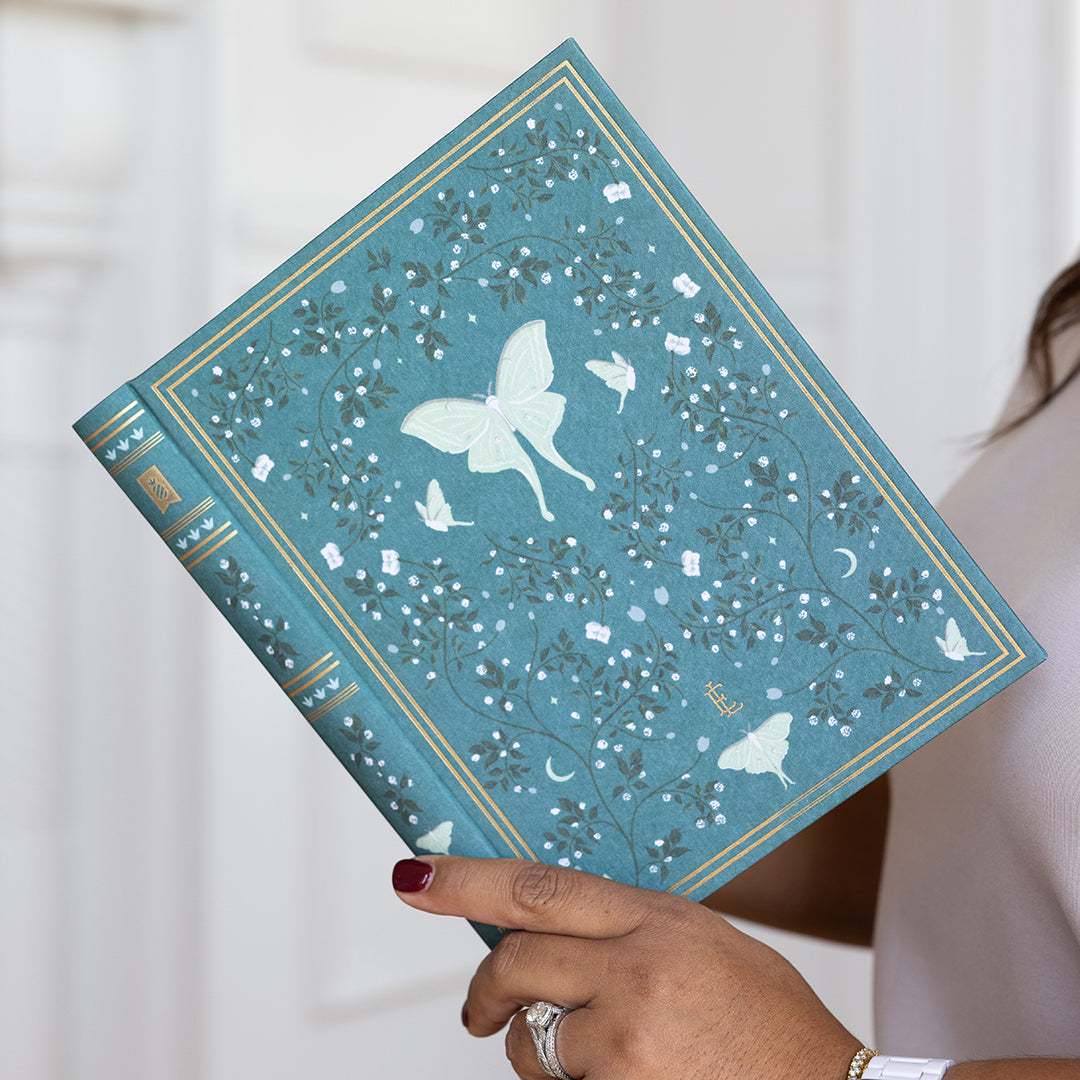 Woman holding Luna Moths Linen Journal