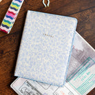 Misty Meadow floral passport holder with travel documents by Simplified by Emily Ley