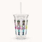 The Simplified Clear Tumbler - Nutcrackers is a 16oz cup with lid and straw, featuring colorful nutcracker illustrations—ideal as a reusable festive drinkware option.