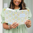 Woman holding Pineapple Charm bookbound weekly planner