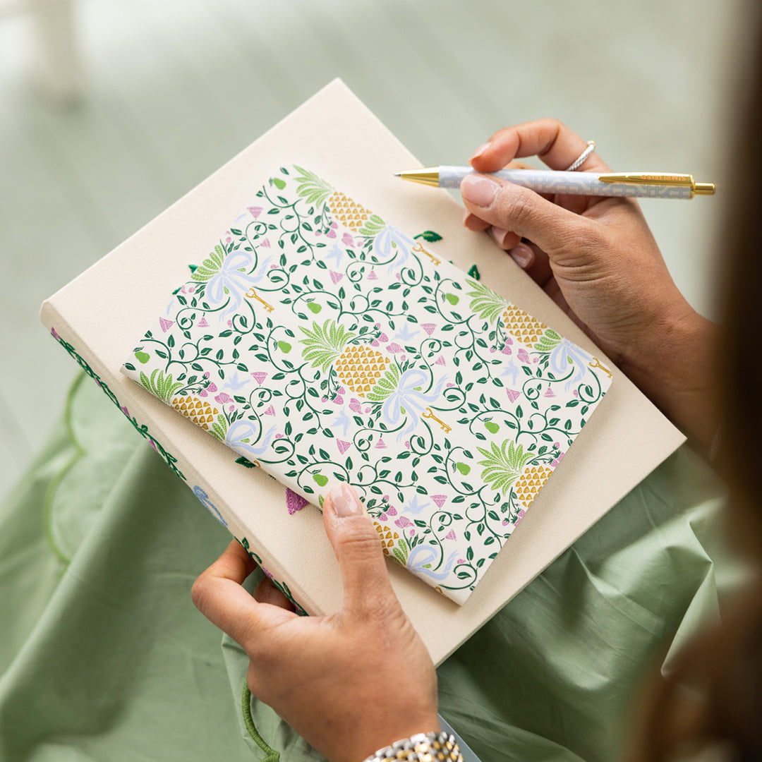 Woman holding Pineapple Charm mini notebook