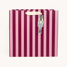 Berry Stripe Large Gift Bag in berry and pink stripes with an ivory ribbon handle and a blue Nutcracker gift tag