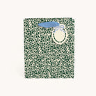 Emerald Floral Medium Gift Bag in a dark green leaf and berry print on ivory with light blue handles and an oval gift tag