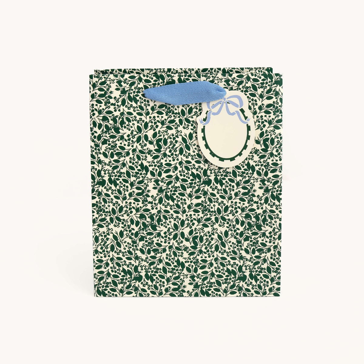 Emerald Floral Medium Gift Bag in a dark green leaf and berry print on ivory with light blue handles and an oval gift tag