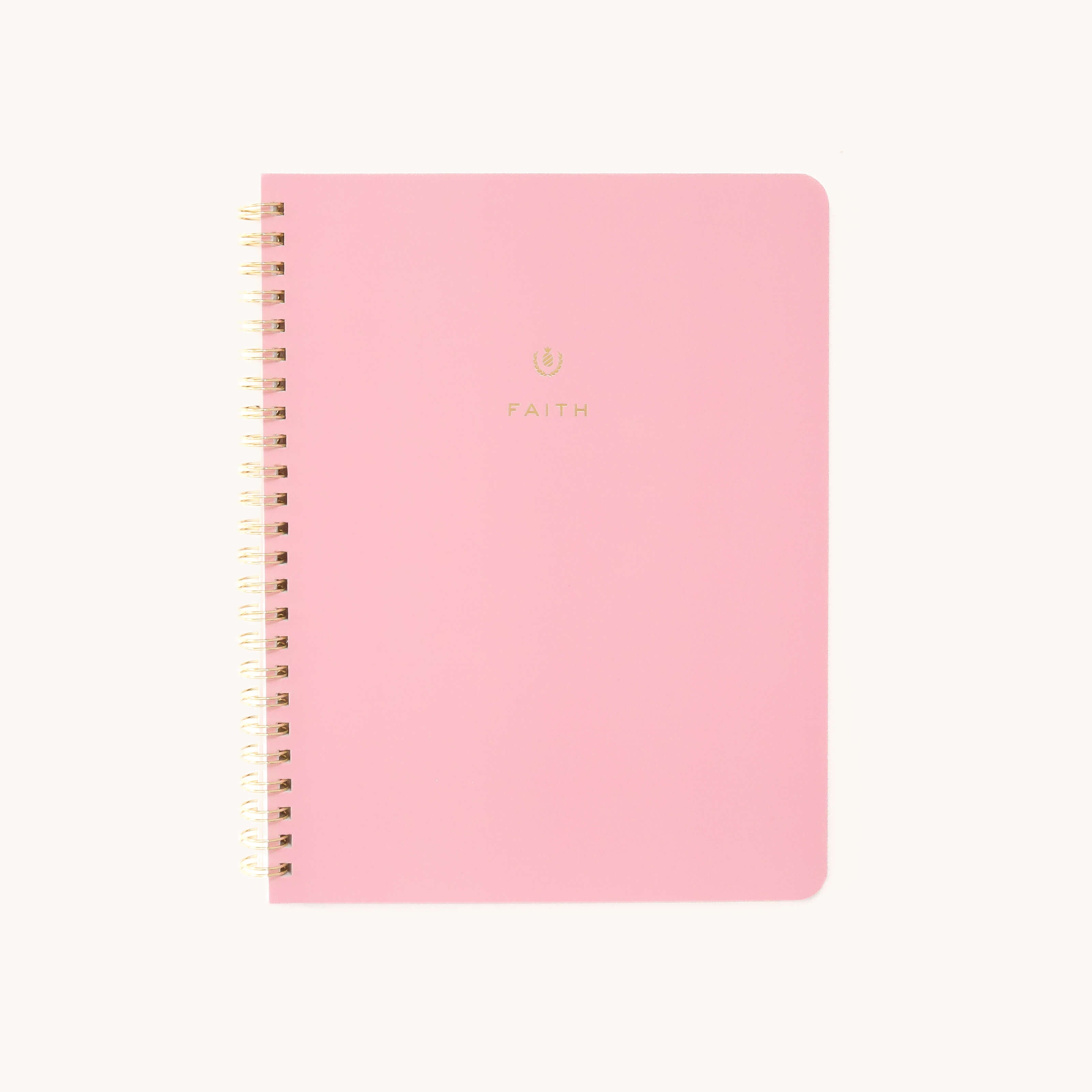 The Workbook - Faith by Simplified is a pink spiral-bound notebook featuring faith in gold and SIMPLIFIED in gold at the bottom. Its off-white background inspires growth—ideal for mapping actionable plans and goals.