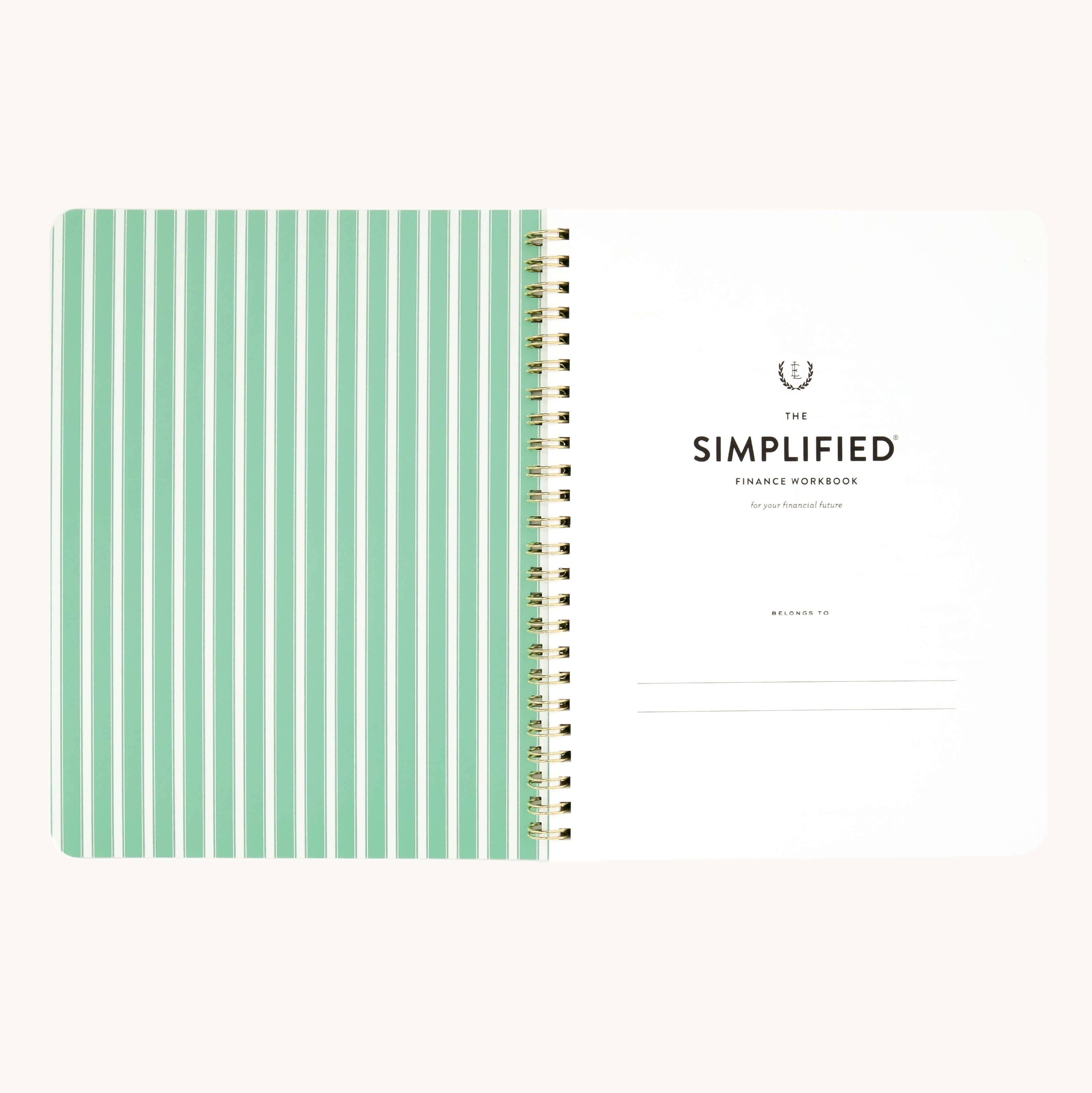 A spiral-bound notebook with left pages featuring green lines and a right page titled Workbook - Finances by Simplified. This money management tool includes a Belongs to section at the bottom to help you achieve your financial goals.