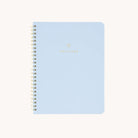 A light blue spiral-bound wellness workbook titled Wellness features gold and the brand Simplified in smaller gold caps at the bottom—ideal for tracking goals and embracing self-care.