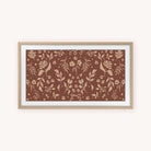 The "Frame TV Art - Fall Blooms" by Simplified features a brown background with symmetrical light tan botanical designs. A light wood frame and white mat complete this elegant piece, perfect for enhancing your space.